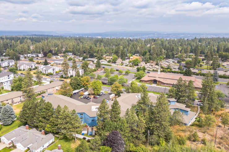 A welcoming community surrounded by lush greenery, offering serenity and connection for all residents.