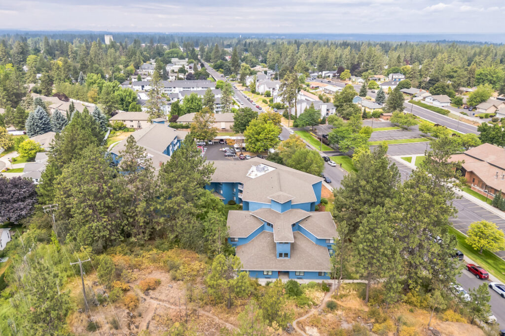 A welcoming community surrounded by lush greenery, offering comfort and connection in a serene neighborhood.