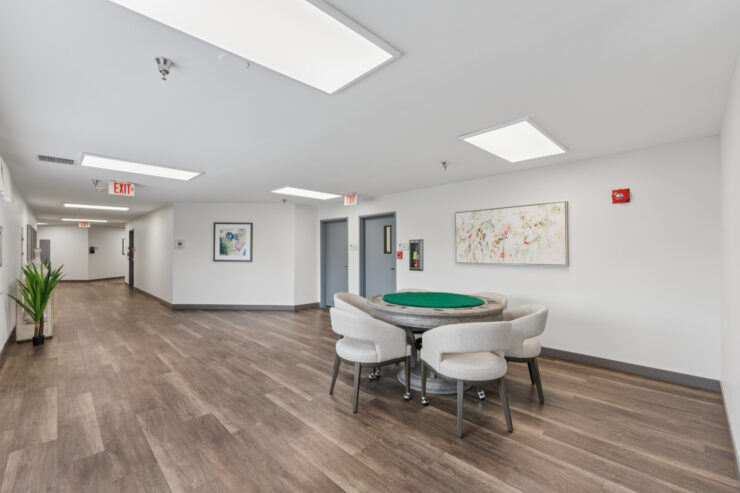 Bright and inviting common area, featuring a game table and comfortable seating for community gatherings.