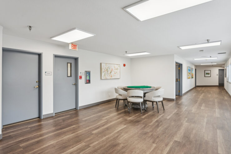Bright, inviting space featuring a card table, fostering community and connection among residents.