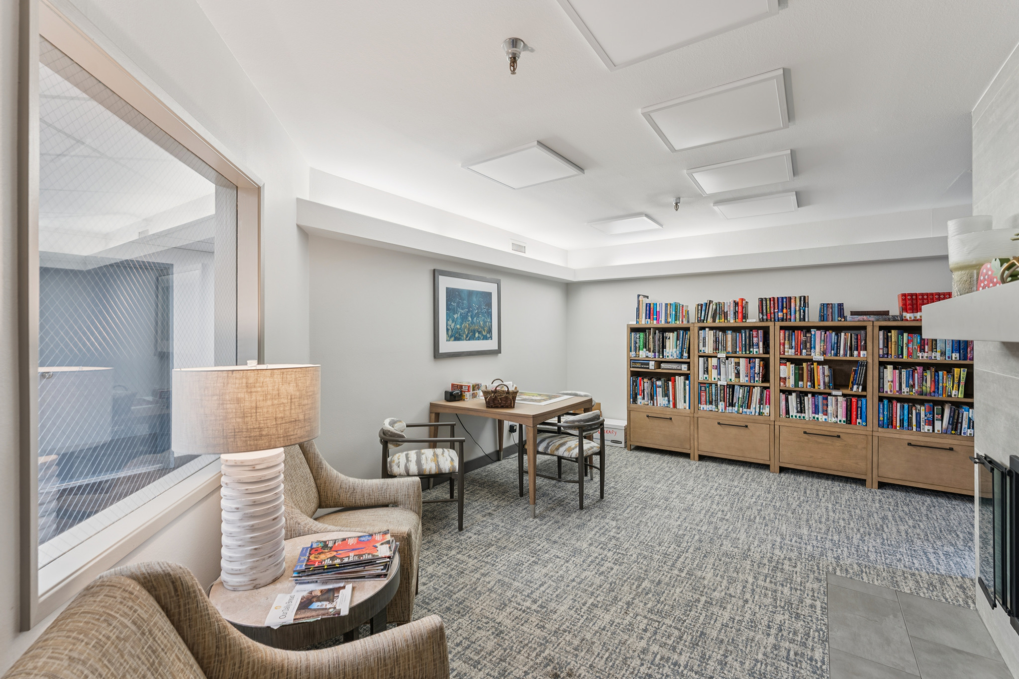 A welcoming reading nook featuring comfortable seating, bookshelves, and warm lighting for community engagement.
