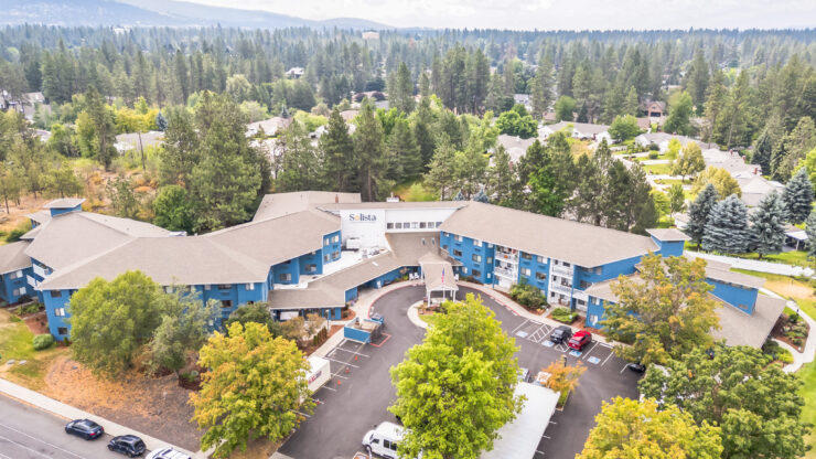 A welcoming community surrounded by nature, featuring vibrant colors and serene pathways for residents.