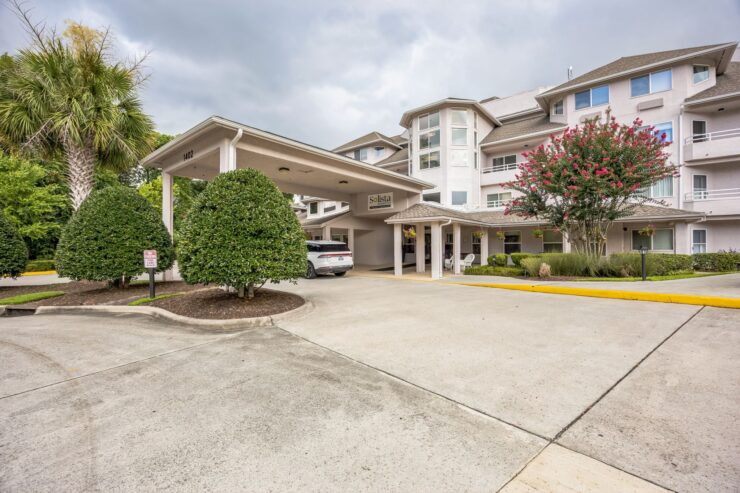Welcoming entrance showcasing a vibrant community, surrounded by greenery and a sense of comfort.