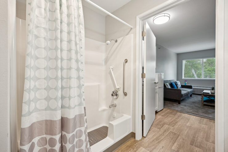 A welcoming bathroom leads to a bright living space, embodying comfort and community spirit.