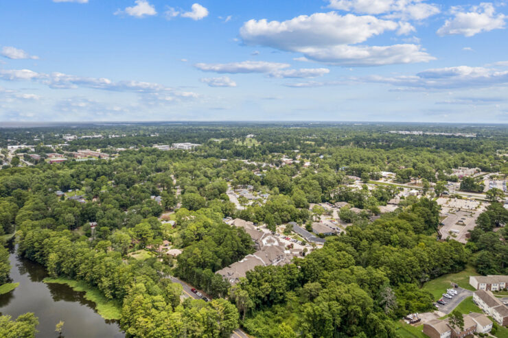 A vibrant community nestled among lush greenery, offering a peaceful and welcoming atmosphere.