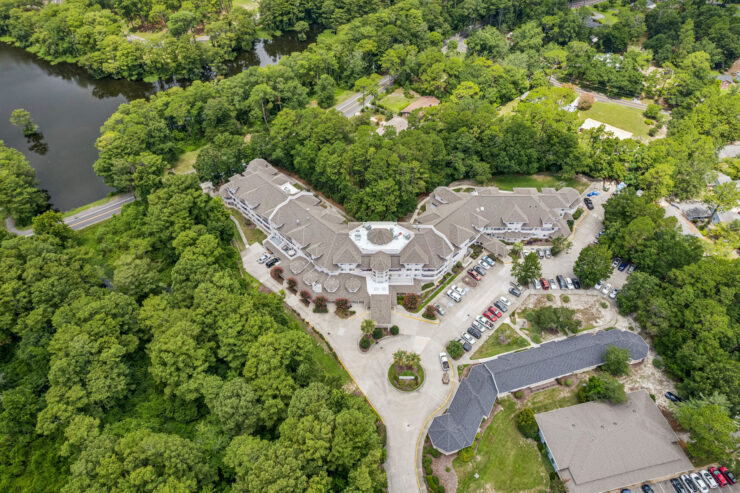 A serene retirement community nestled among lush greenery, fostering connection and comfort.