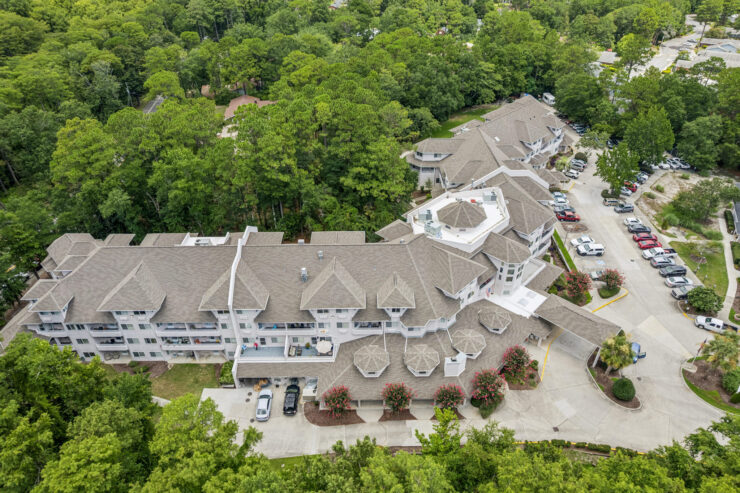 A welcoming retirement community nestled among lush greenery, promoting comfort and connection.