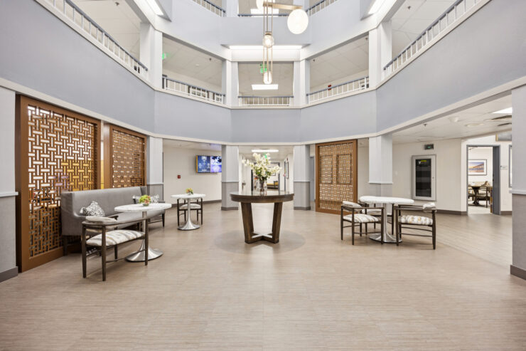 A welcoming community space featuring elegant decor, inviting seating, and vibrant floral arrangements.