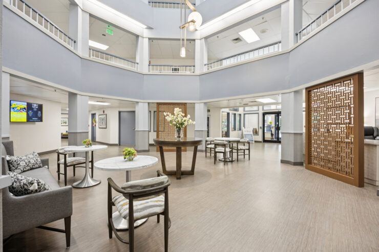 Bright and inviting common area, featuring elegant seating and vibrant floral arrangements, fostering community and comfort.