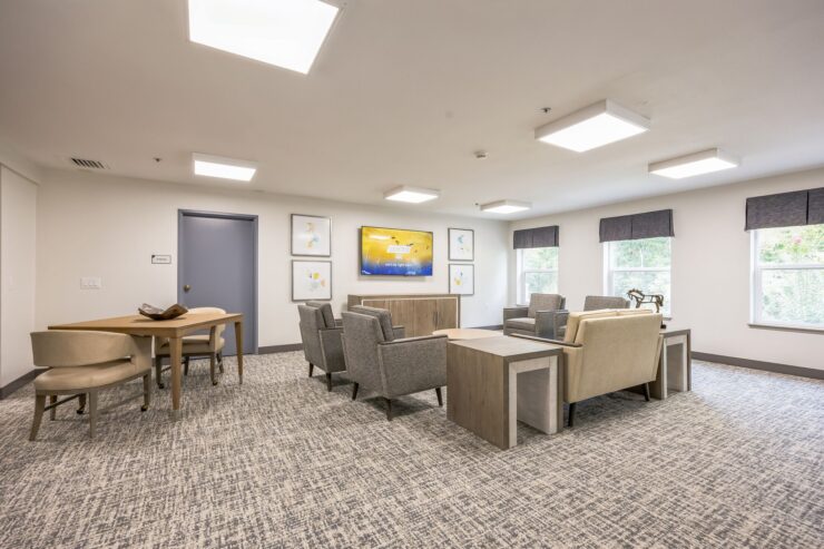 A welcoming lounge area designed for relaxation and community, featuring comfortable seating and natural light.