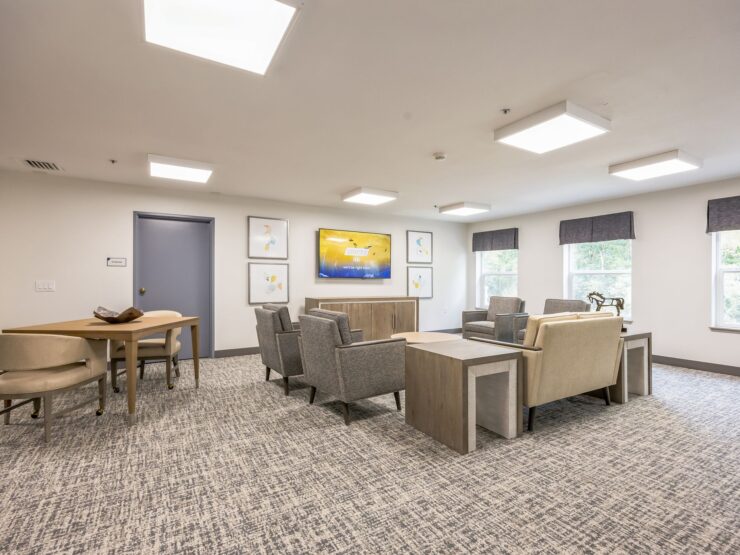 A welcoming lounge area designed for relaxation and community, featuring comfortable seating and natural light.