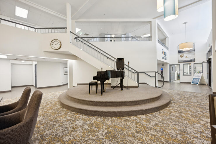A welcoming space featuring a grand piano, inviting residents to gather and enjoy shared moments.