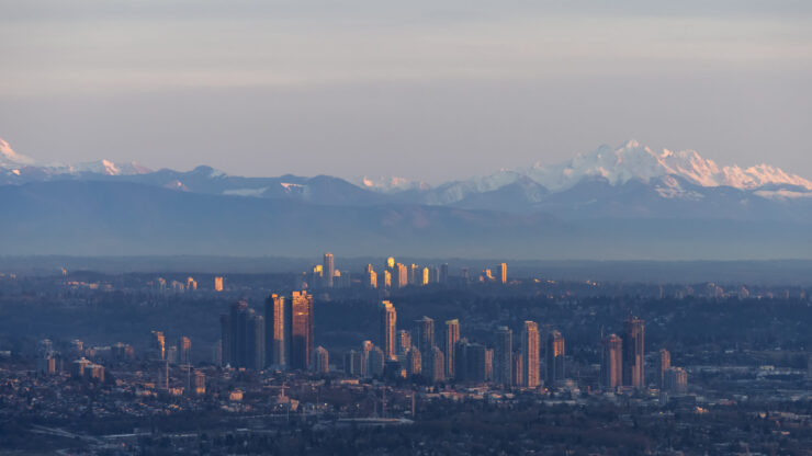 A serene view of a vibrant community against majestic mountains, embodying peace and connection.