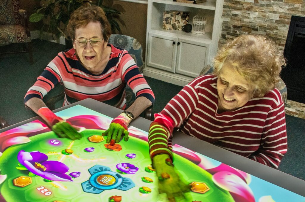 Engaging residents enjoy interactive games, fostering joy and connection in a welcoming environment.