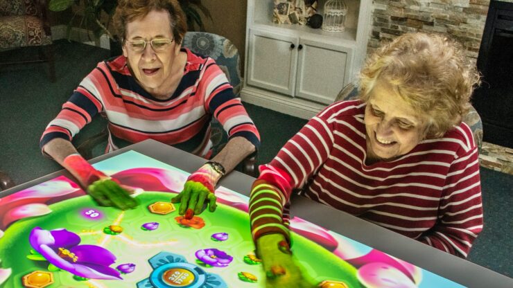 Engaging residents enjoy interactive games, fostering joy and connection in a welcoming environment.
