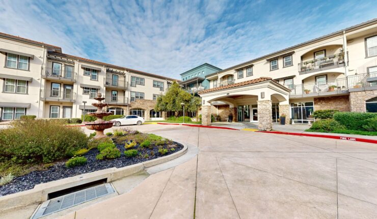 A welcoming entrance with lush landscaping and a serene atmosphere, inviting residents to connect and thrive.