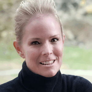 A welcoming smile radiates warmth, embodying community spirit and comfort in a serene setting.