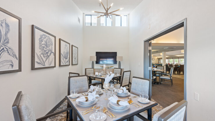 An inviting dining area, beautifully set for meals, promoting warmth and community among residents.