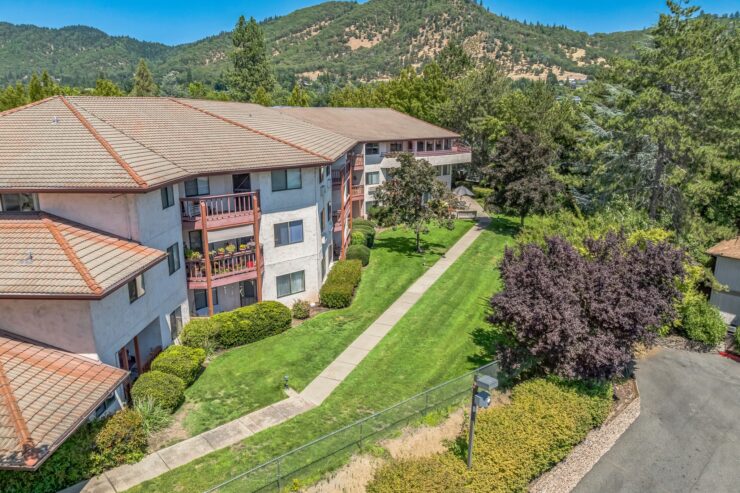 Welcoming community nestled among lush greenery, featuring accessible pathways and inviting surroundings.