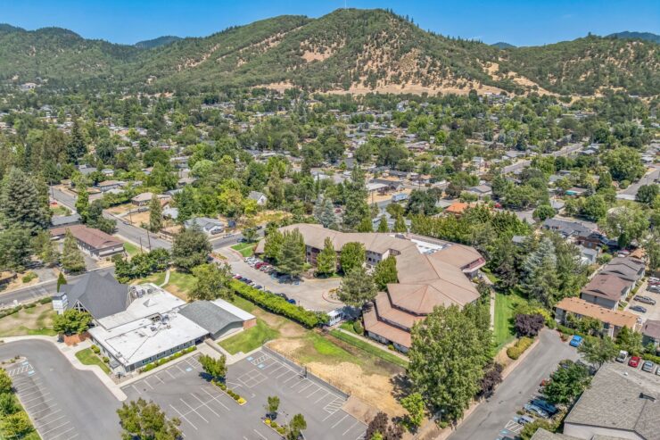 A welcoming community surrounded by lush greenery and scenic hills, perfect for serene living.