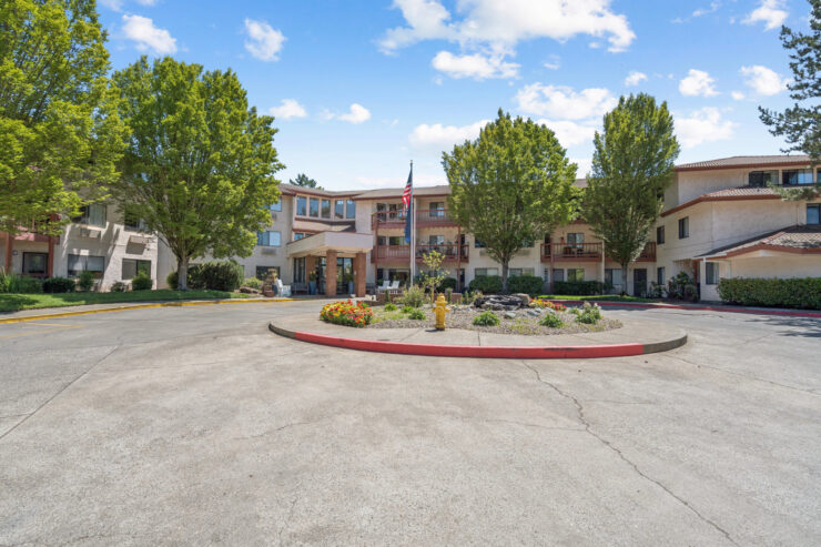 A welcoming entrance surrounded by vibrant greenery, inviting residents to enjoy community life.