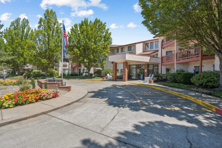 A welcoming entrance surrounded by lush greenery, inviting residents to enjoy a vibrant community atmosphere.