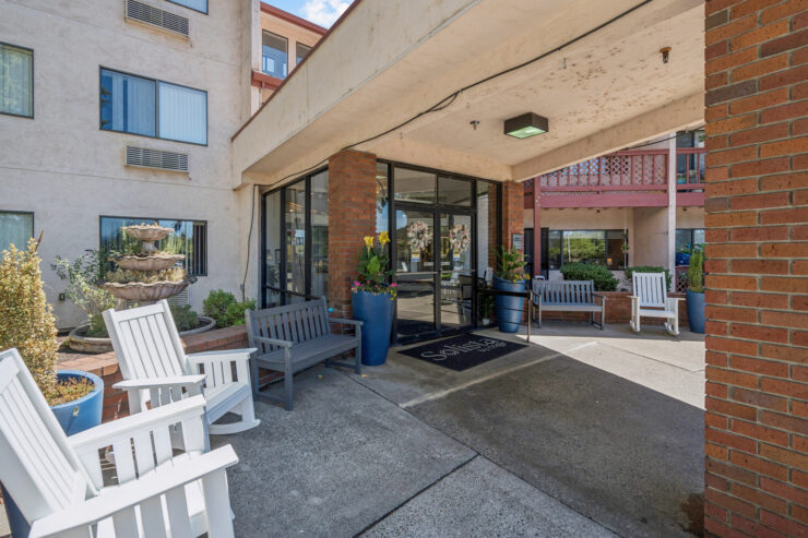 Welcoming entrance with comfortable seating, vibrant plants, and a serene fountain, fostering community.