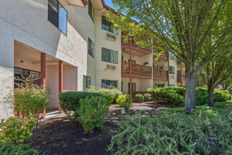 Welcoming community setting with lush greenery and comfortable outdoor spaces for relaxation and connection.