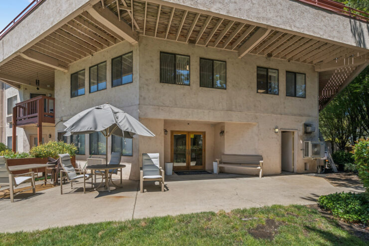 A welcoming outdoor space with seating, inviting residents to relax and enjoy community life.