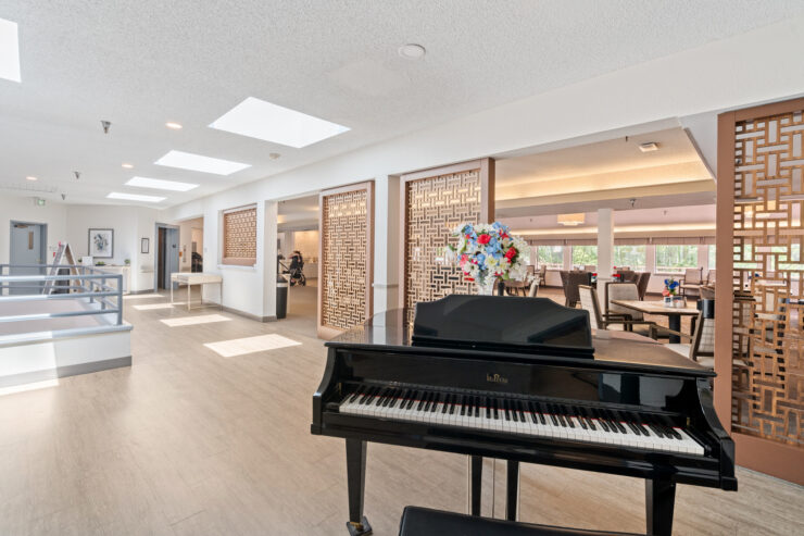 Bright, inviting space with a grand piano and cheerful decor, fostering community and connection.