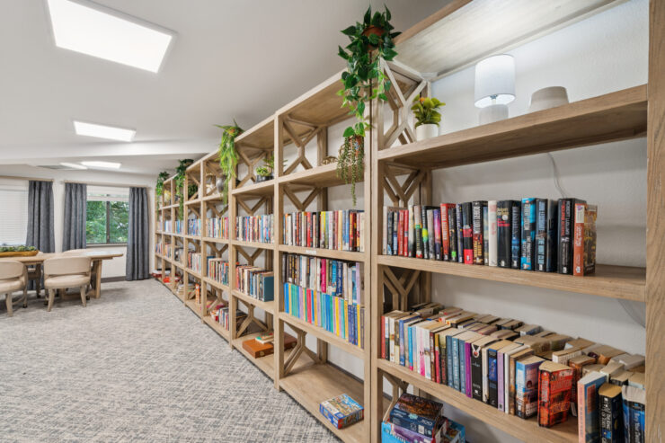 A welcoming library space filled with books, plants, and natural light, perfect for community gatherings.