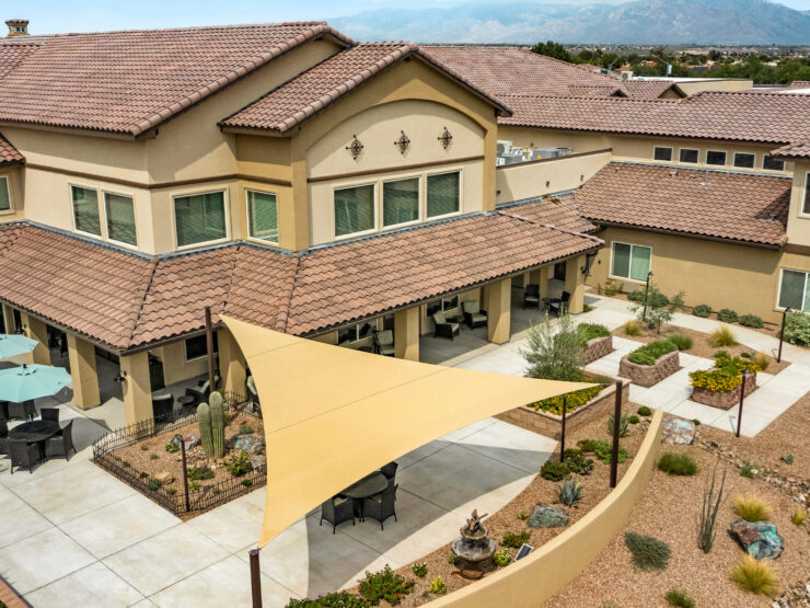 A welcoming retirement community featuring shaded outdoor spaces, inviting residents to connect and relax.