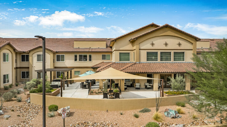 A welcoming retirement community surrounded by beautiful landscaping and inviting outdoor spaces.