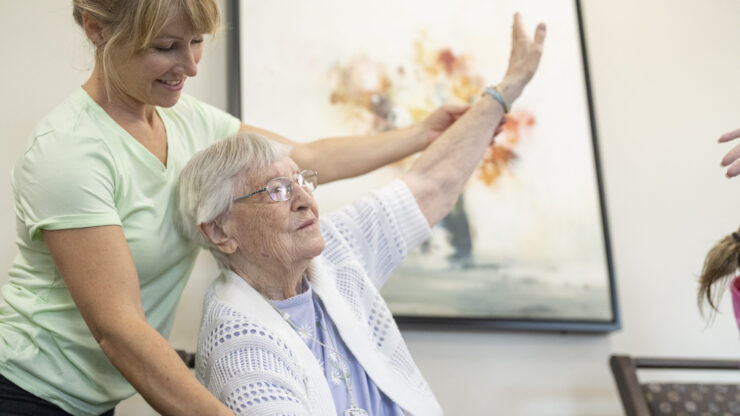 A warm interaction between a caregiver and resident fosters a sense of community and support.