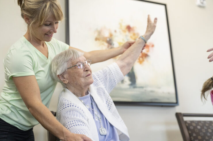 A warm interaction between a caregiver and resident fosters a sense of community and support.