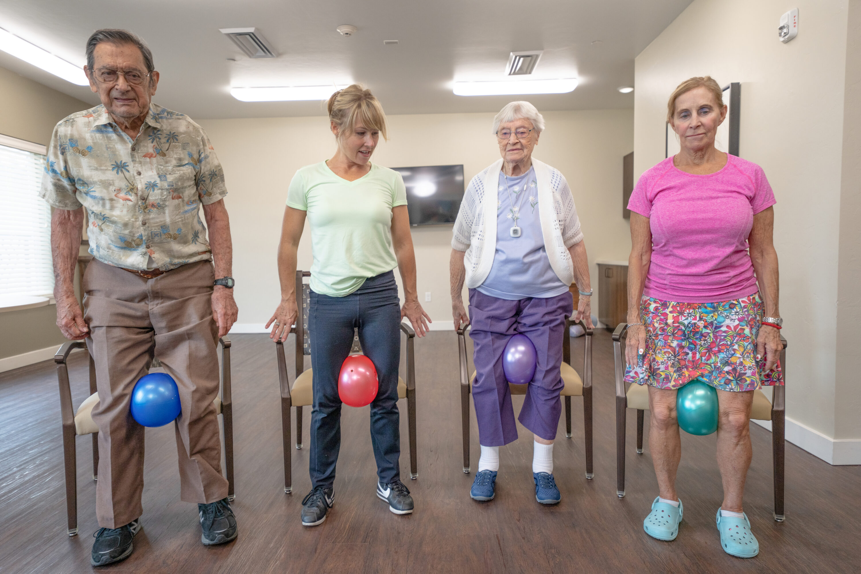 Residents engage in a fun exercise activity, fostering community and connection in a welcoming space.