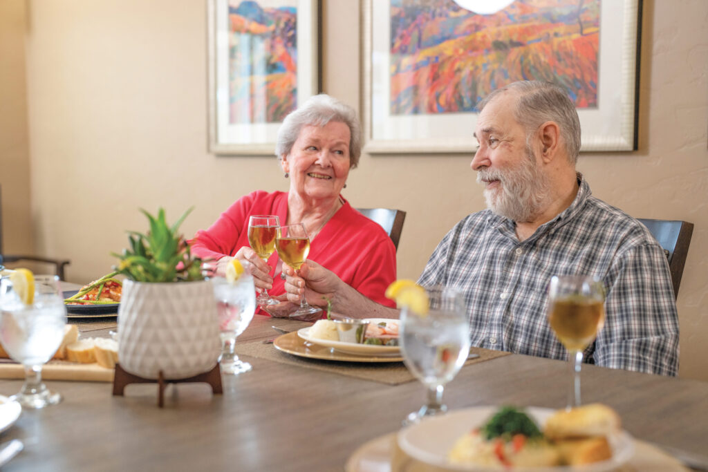 Warm smiles and lively conversations create a welcoming atmosphere at this vibrant dining setting.