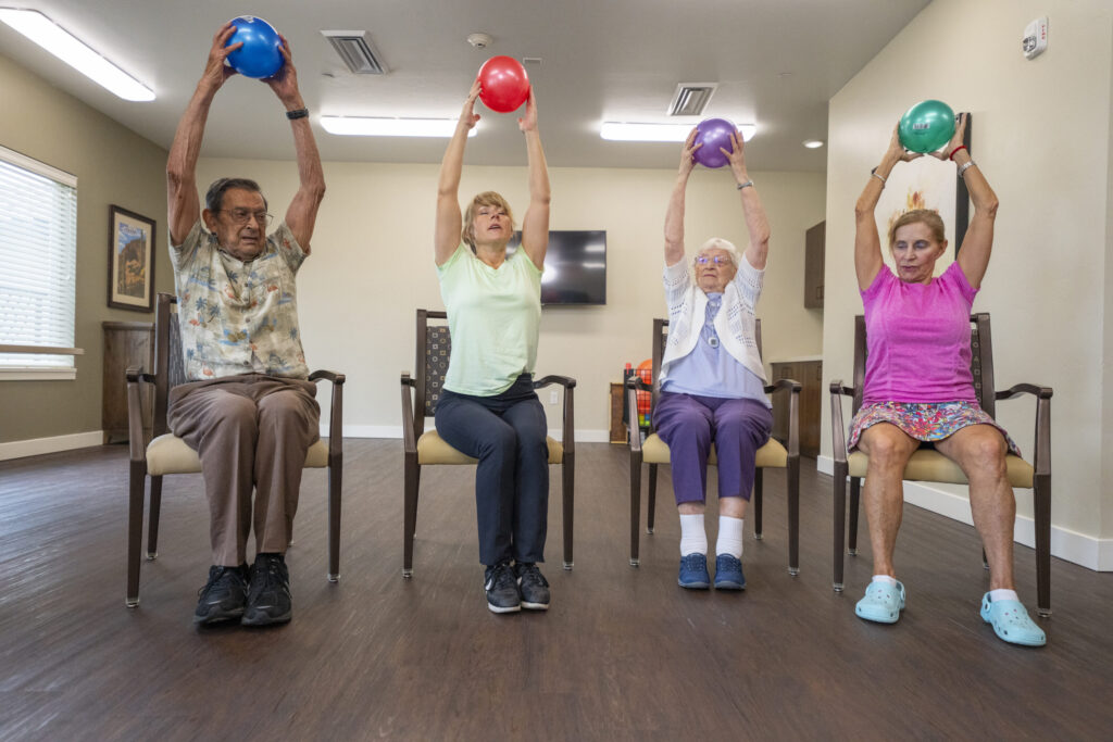 Residents engage in a joyful group exercise, fostering community and promoting wellness together.