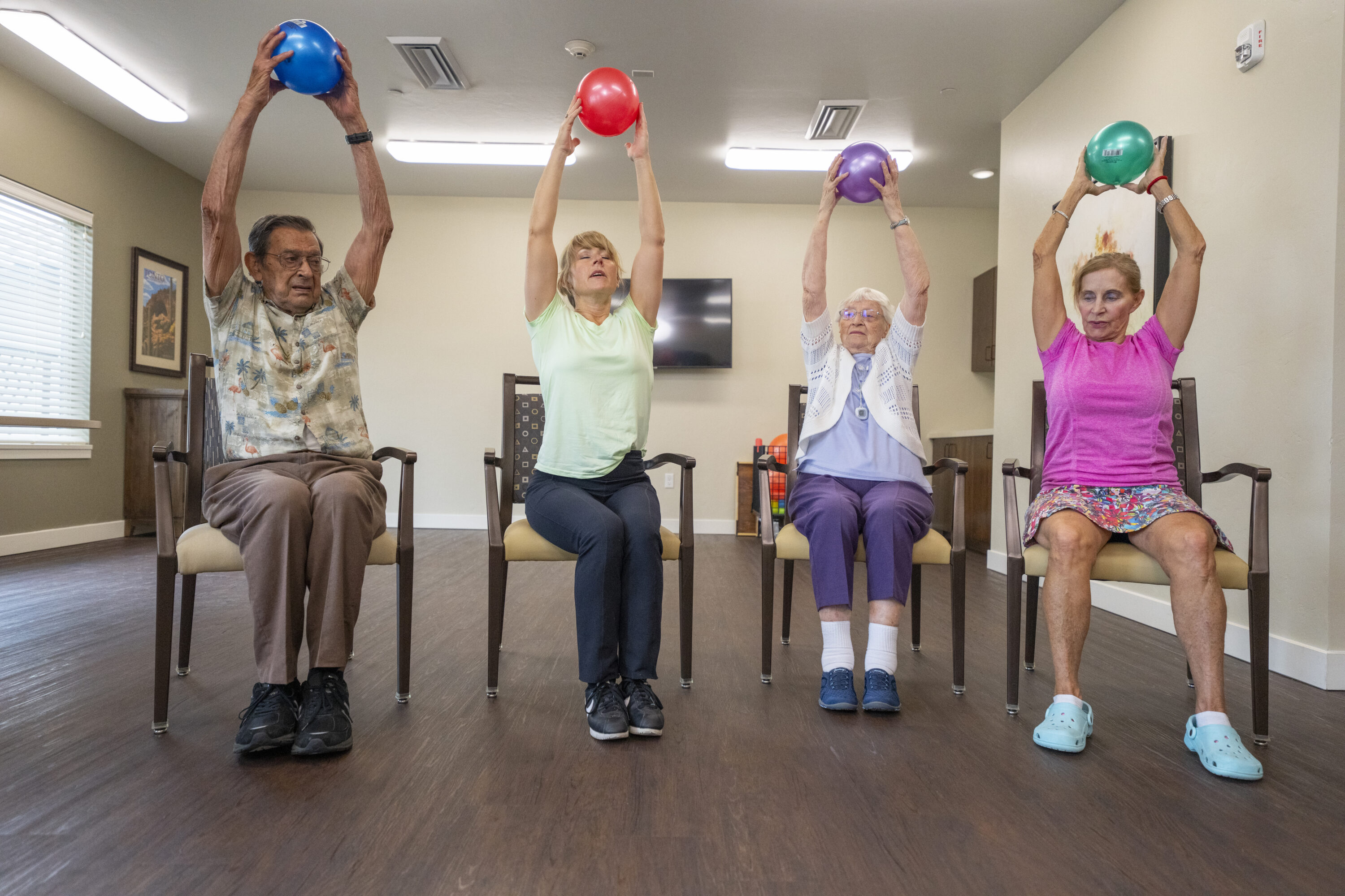 Residents engage in a joyful group exercise, fostering community and promoting wellness together.