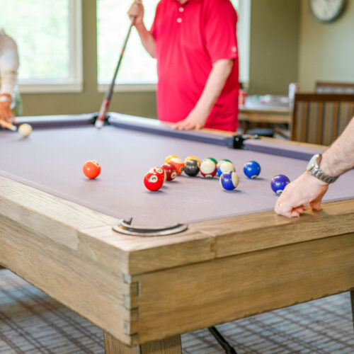 Residents enjoy friendly games of billiards, fostering community and connection in a welcoming space.
