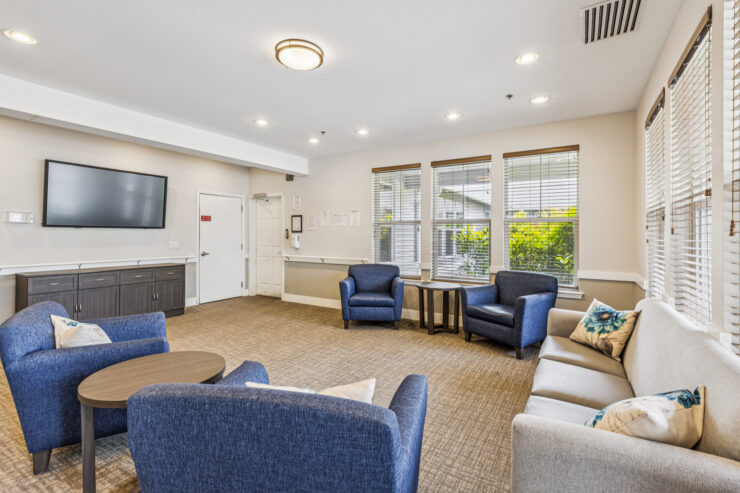 A welcoming community space filled with comfortable seating, natural light, and a warm atmosphere.