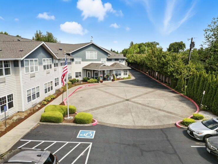 A welcoming community center surrounded by lush greenery, inviting residents to enjoy a vibrant lifestyle.