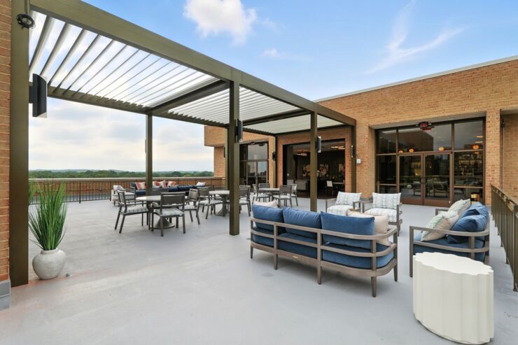 A welcoming terrace features comfortable seating, inviting residents to enjoy scenic views and community gatherings.