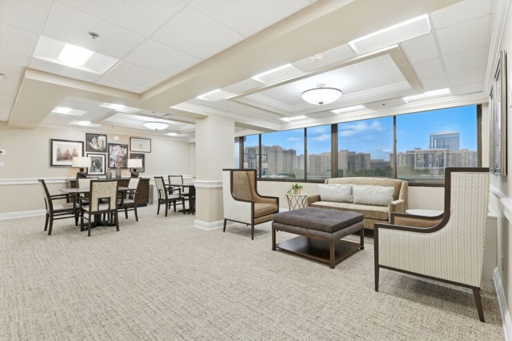 A bright, inviting communal space with comfortable seating and large windows, fostering connection and warmth.