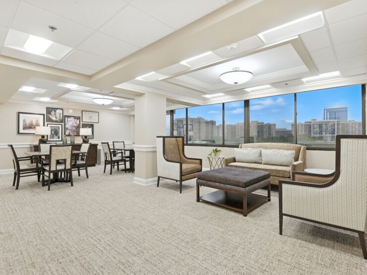 A bright, inviting communal space with comfortable seating and large windows, fostering connection and warmth.