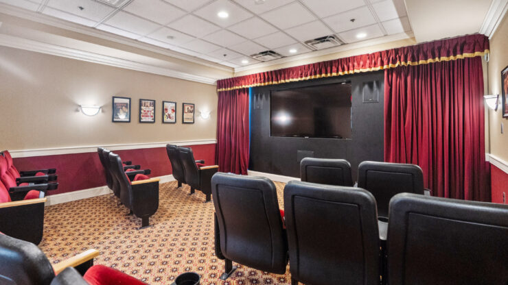 A welcoming theater space designed for community gatherings, featuring comfortable seating and a warm ambiance.