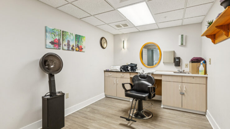A welcoming salon space designed for relaxation and community, featuring vibrant artwork and modern amenities.