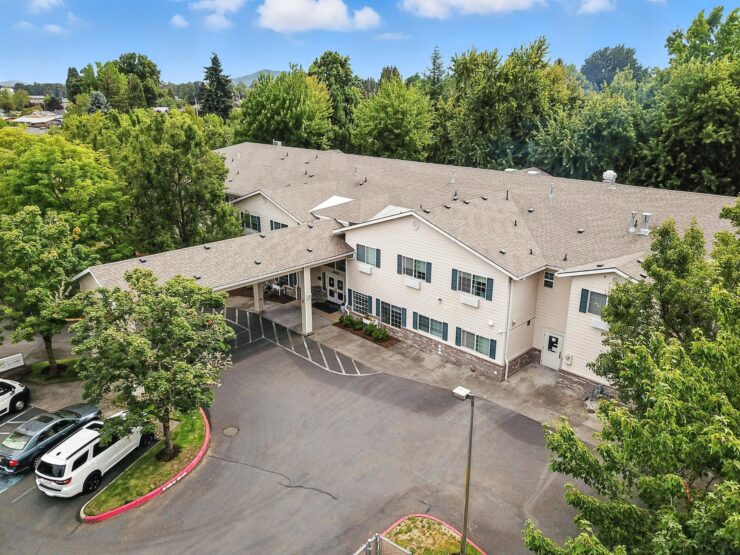 A welcoming retirement community surrounded by lush greenery, offering comfort and connection.