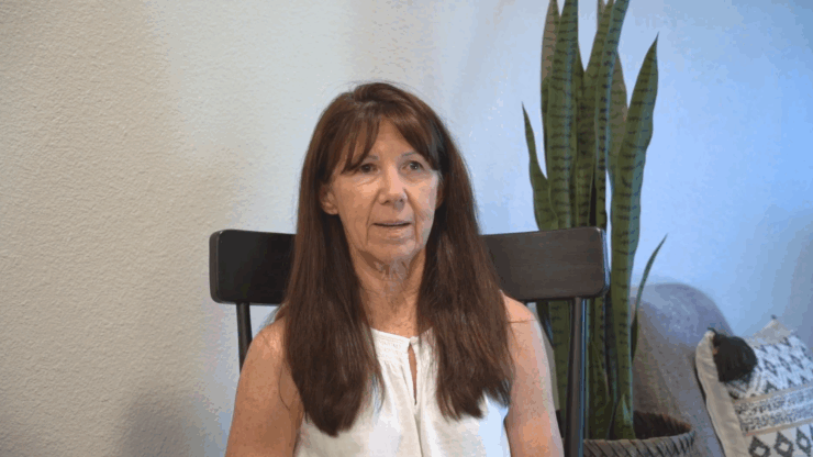 A welcoming atmosphere with a resident sharing their story, surrounded by greenery and comfort.