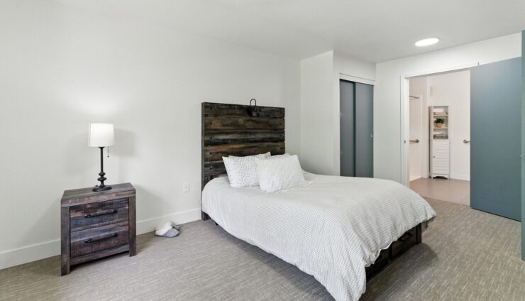 Bright and inviting, this serene bedroom offers comfort and tranquility for a welcoming community experience.